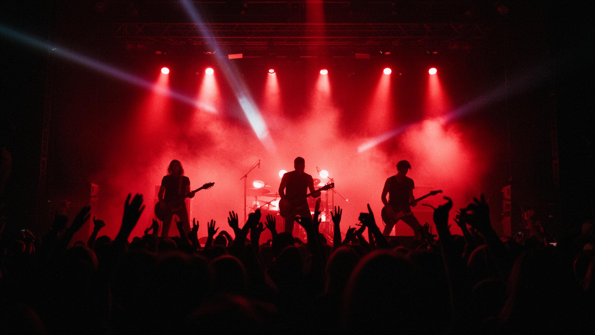 Light Up The Moon performing live on stage with crimson lights